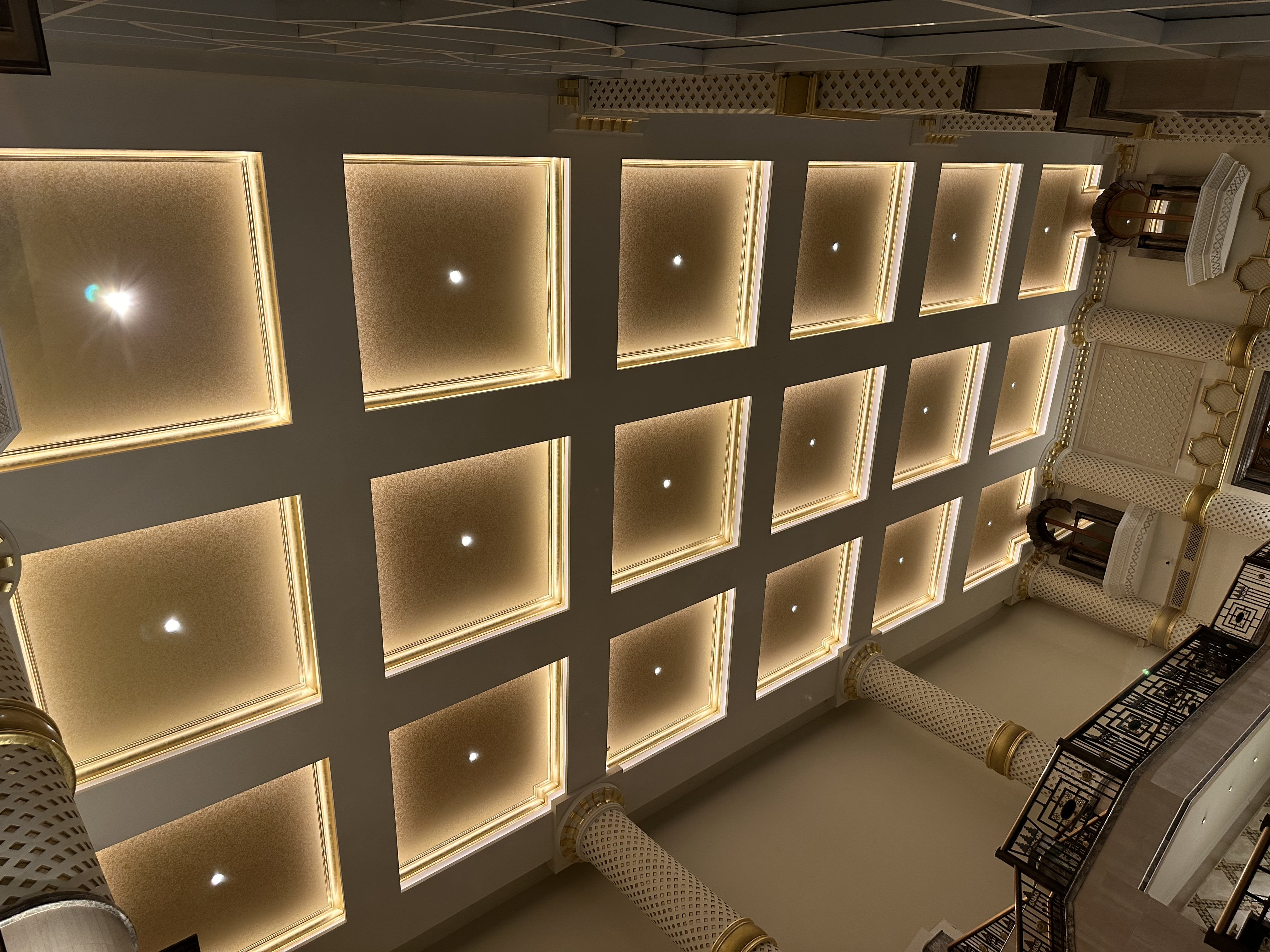 Decorative geometric ceiling with integrated warm lighting